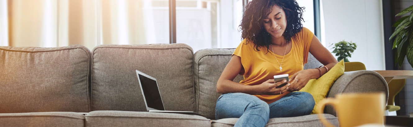 Person sitting on a couch using a smartphone
